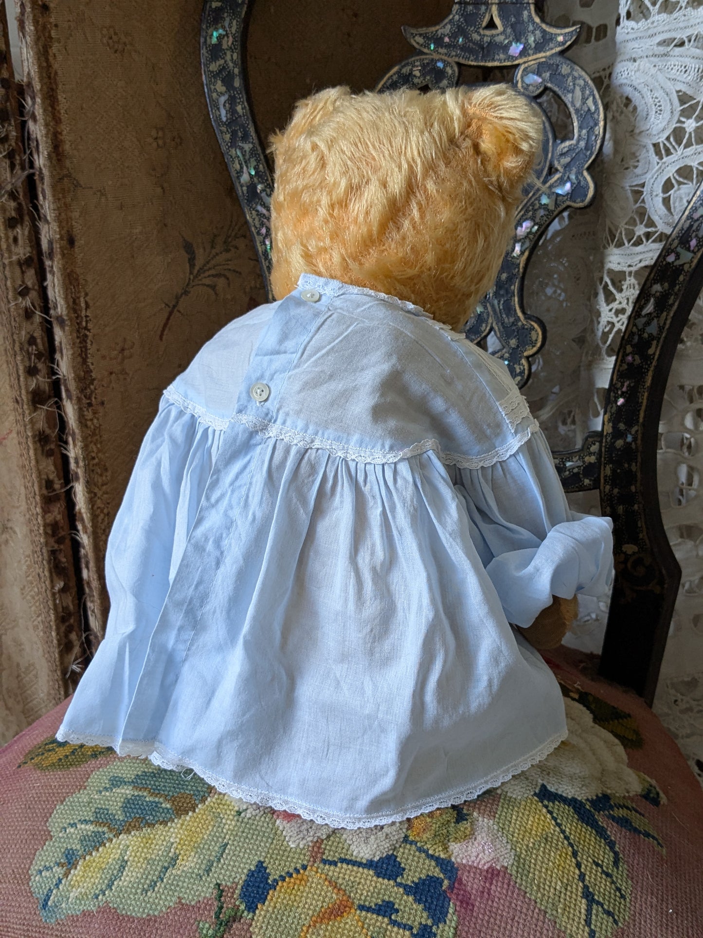 Vintage teddy bear in a cute vintage dress