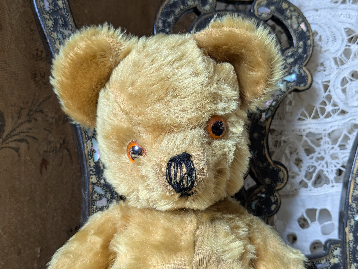 Vintage teddy bear is pretty antique dress