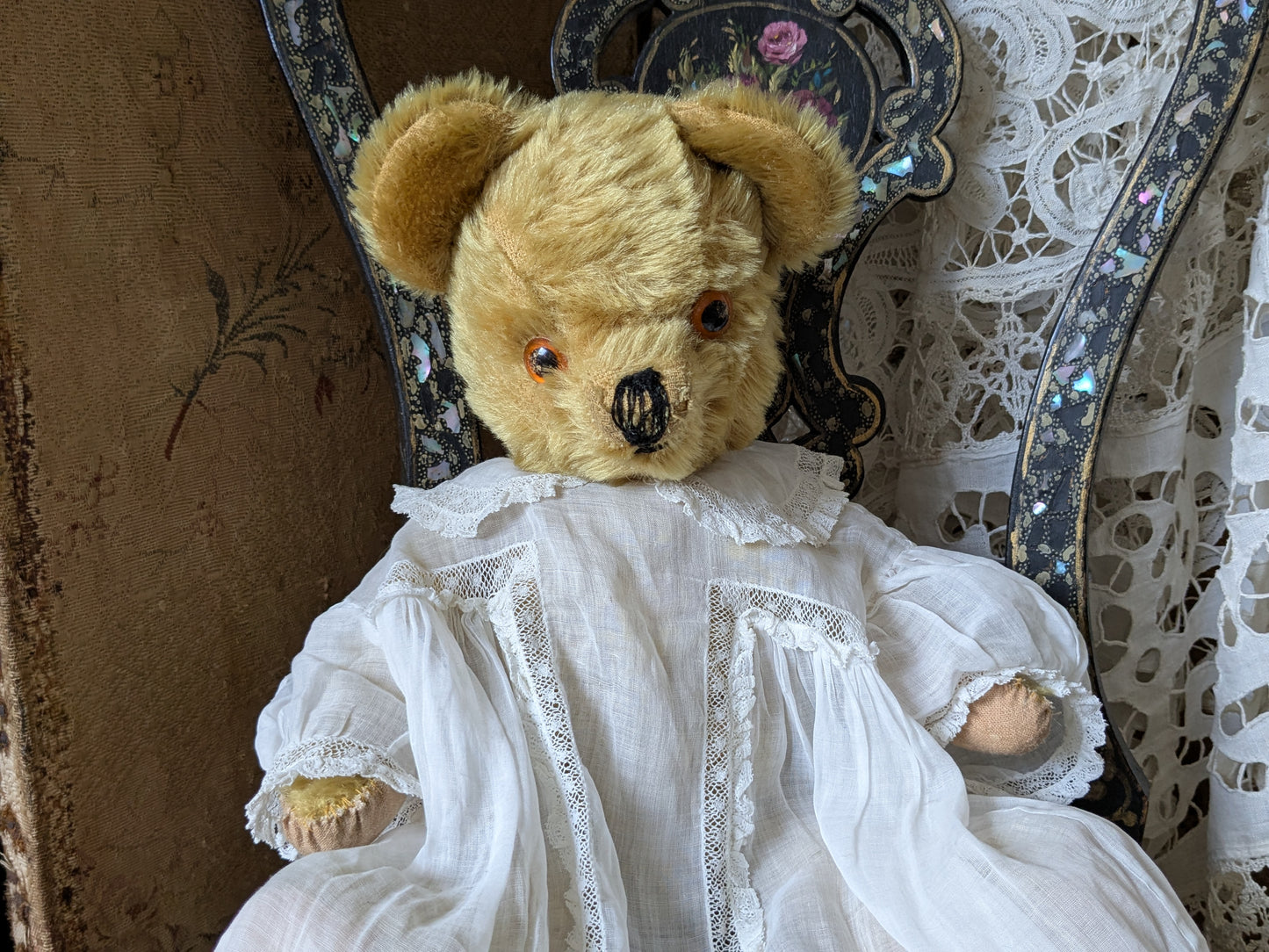 Vintage teddy bear is pretty antique dress