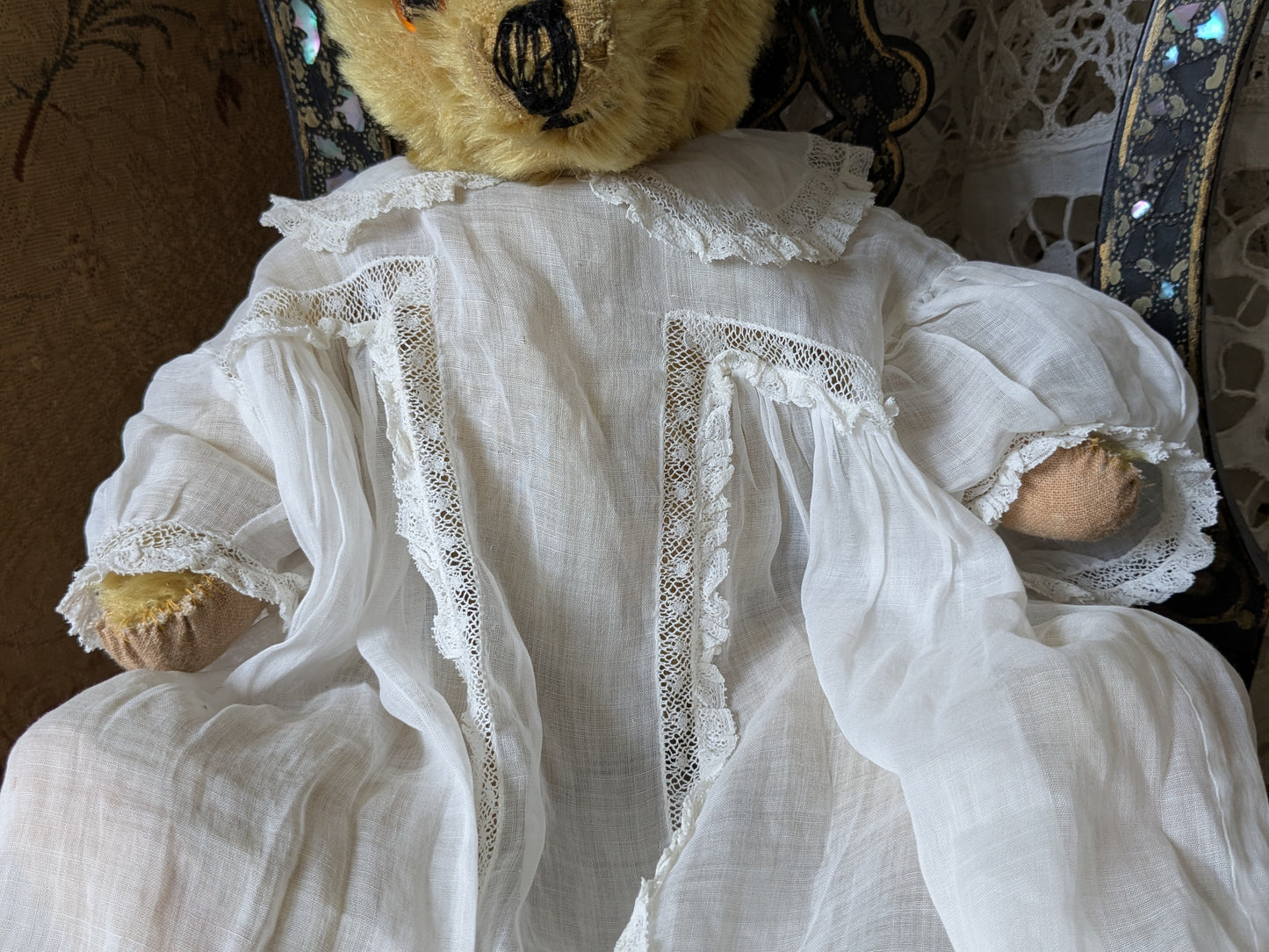 Vintage teddy bear is pretty antique dress