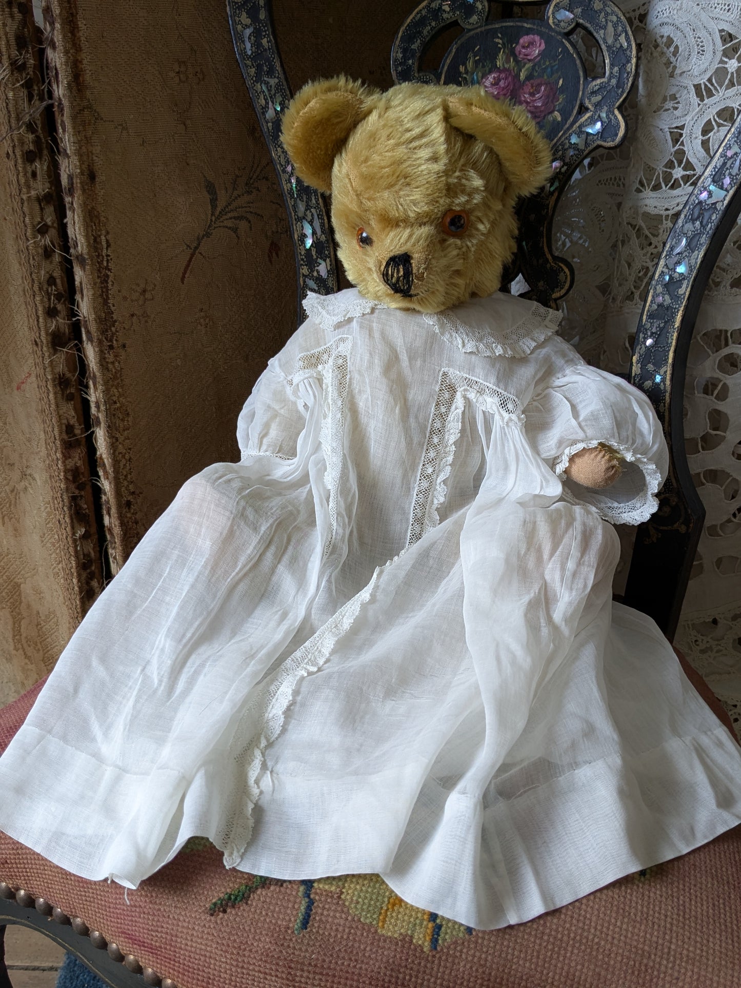 Vintage teddy bear is pretty antique dress