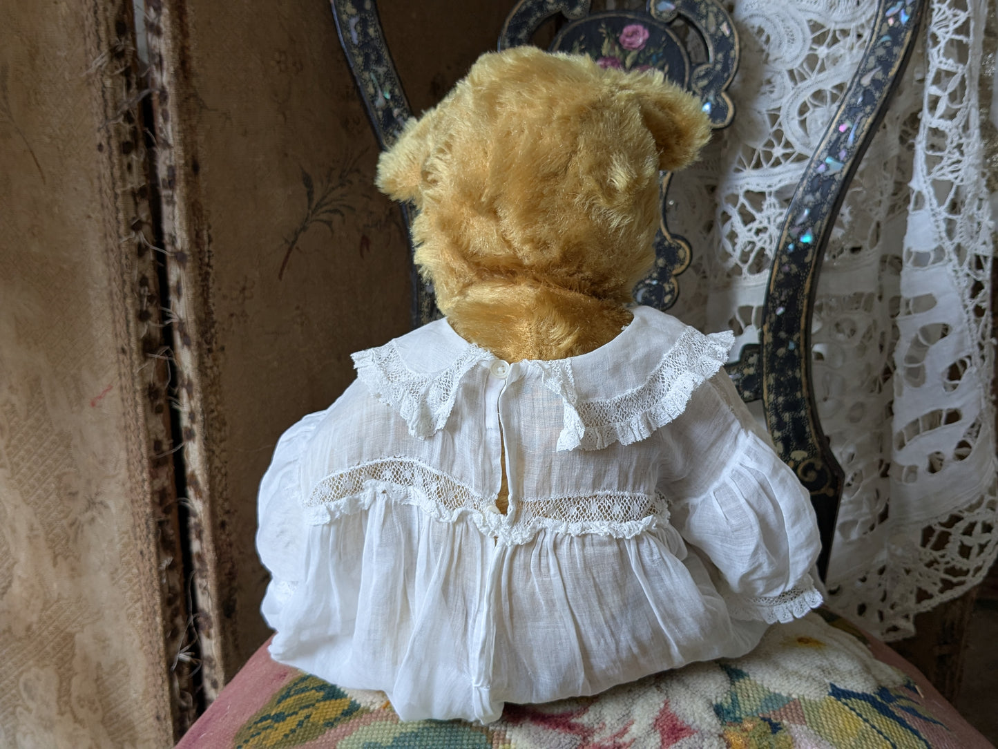 Vintage teddy bear is pretty antique dress