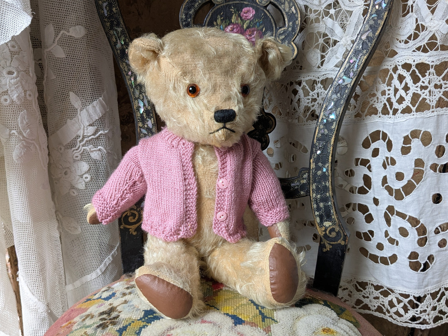 Vintage teddy bear in pink cardigan