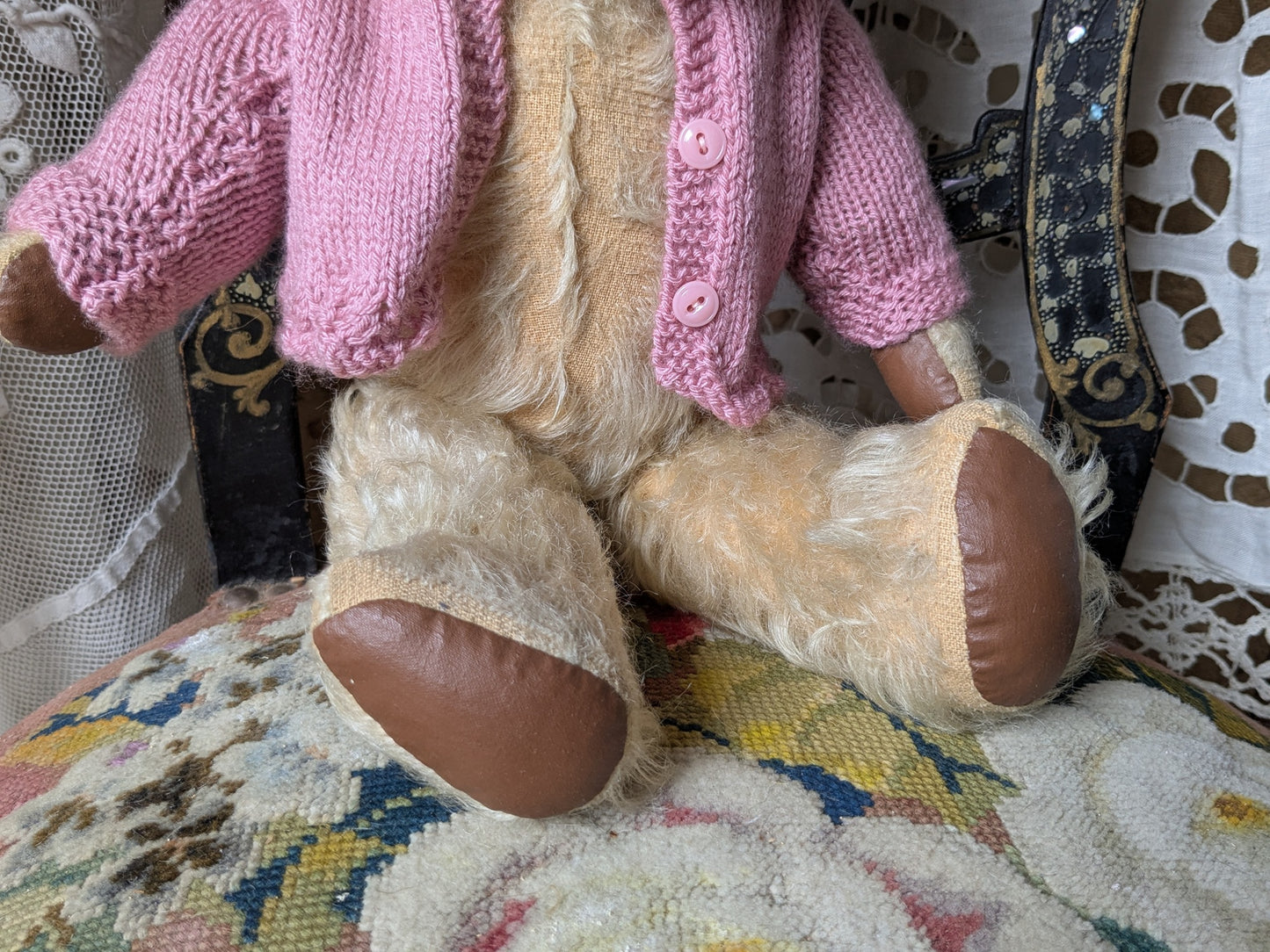 Vintage teddy bear in pink cardigan