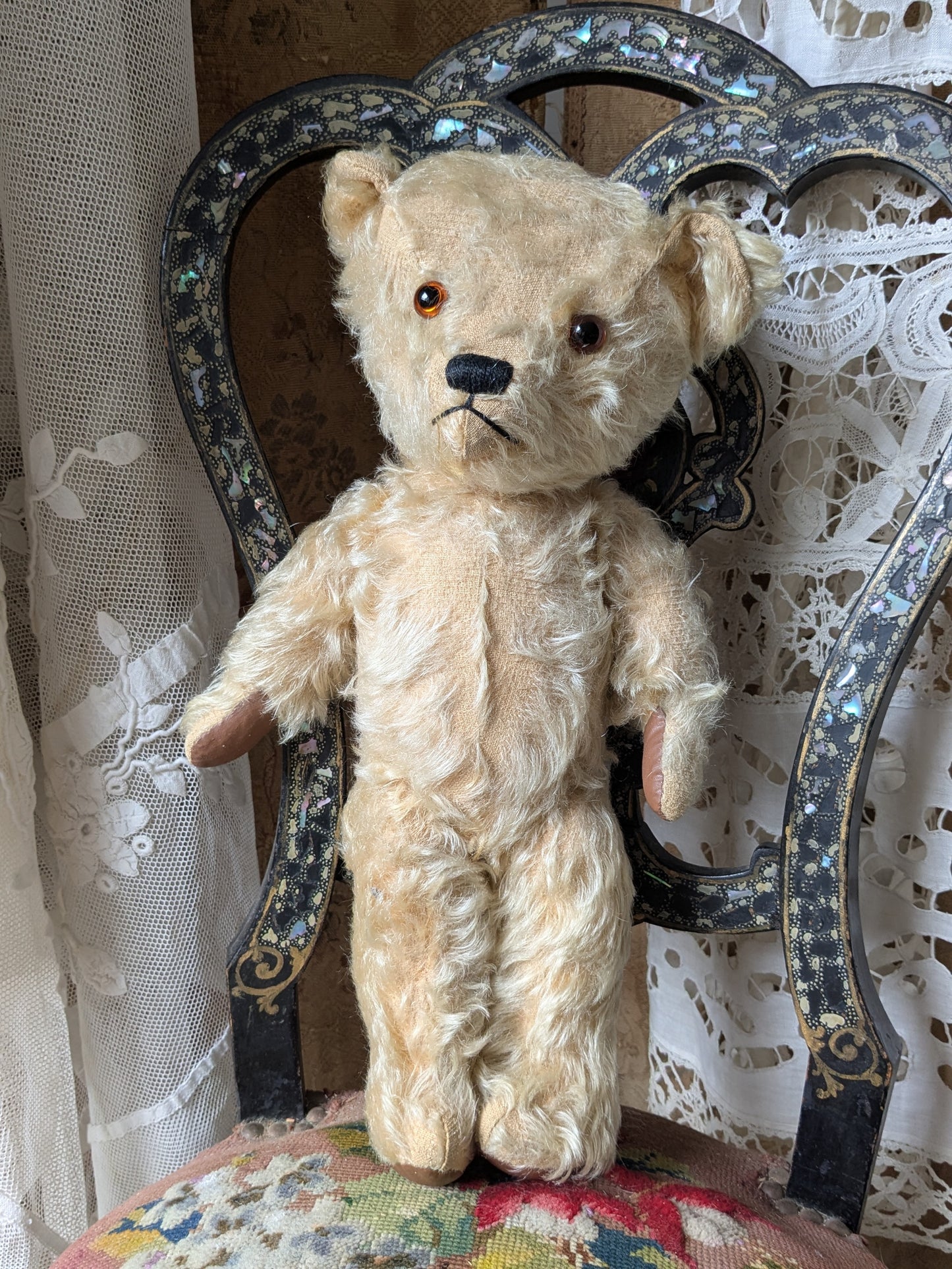 Vintage teddy bear in pink cardigan