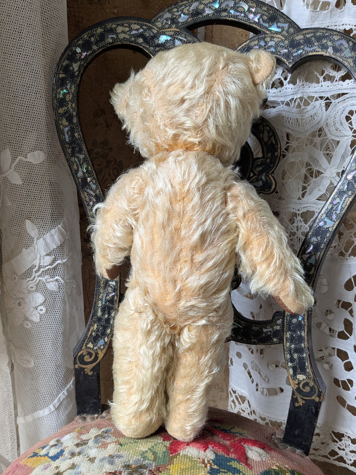 Vintage teddy bear in pink cardigan
