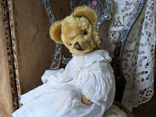 Vintage teddy bear is pretty antique dress