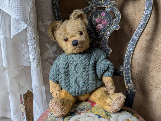 Vintage teddy bear in hand knitted Aran jumper