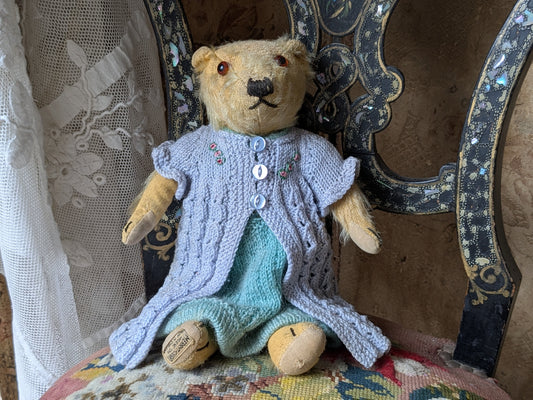 Small vintage Merrythought bear in charming clothes